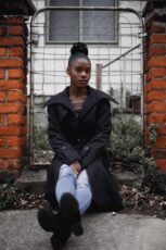 A Woman Sitting On Steps Outside