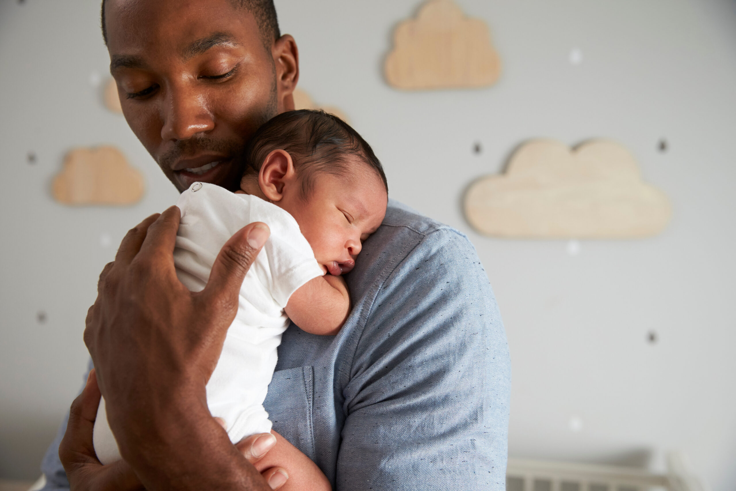 A new father holding a newborn baby