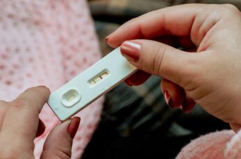 Older Woman Holding Positive Pregnancy Test